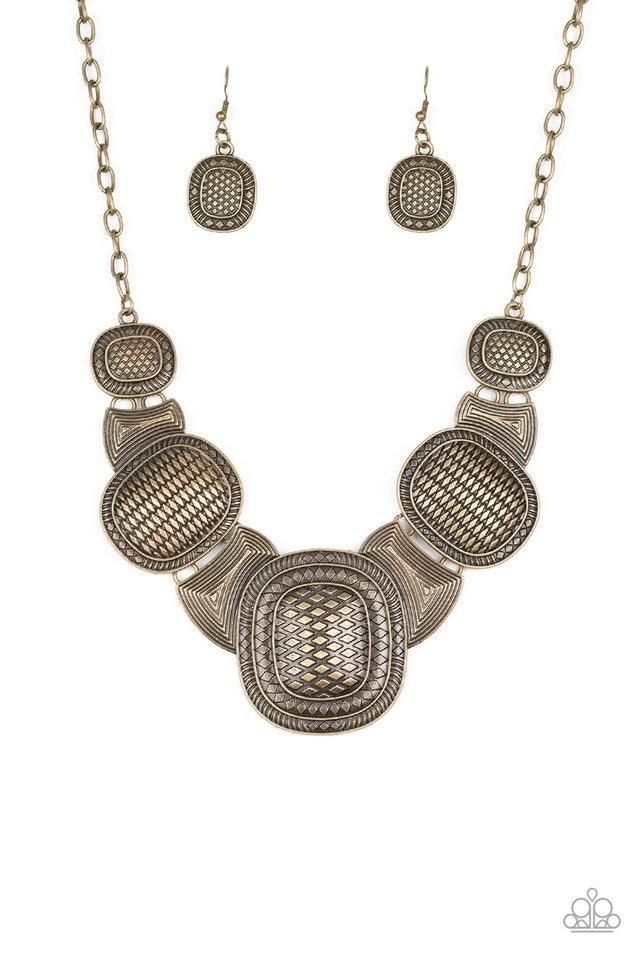 Paparazzi Accessories Prehistoric Powerhouse - Brass Radiating with geometric and linear details, ornate brass plates link below the collar for a bold tribal look. Features an adjustable clasp closure. Sold as one individual necklace. Includes one pair of
