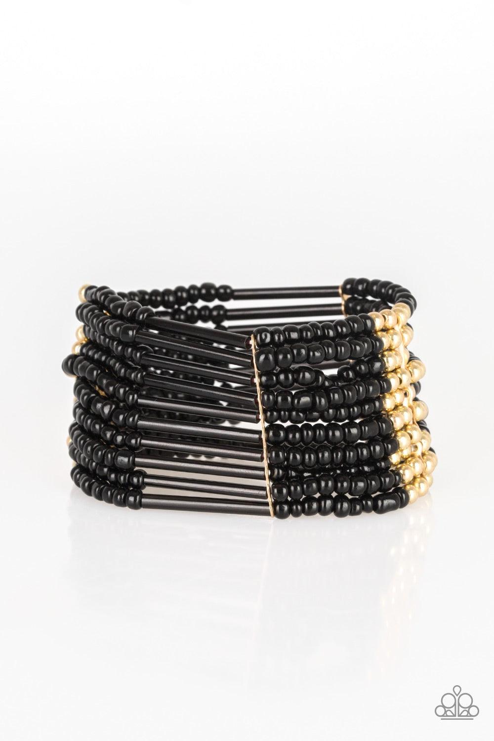 Paparazzi Accessories Rural Retreat - Gold Joined together with metallic fittings, black seed beads are threaded along stretchy elastic bands. Sections of gold beads are sprinkled along the edgy layers, adding hints of shimmer to the seasonal palette. Jew