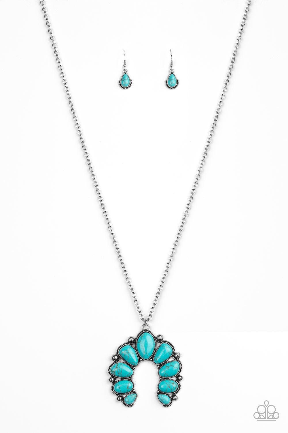 Paparazzi Accessories Stone Monument - Blue Featuring studded silver frames, an asymmetrical collection of refreshing turquoise stones coalesce into an earthy squash blossom pendant at the bottom of a lengthened silver chain. Features an adjustable clasp
