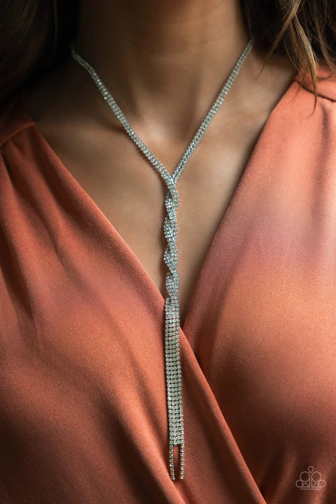 Paparazzi Accessories Impressively Icy - White A twisted chain of glassy rhinestones elegantly drip along a classic silver chain across the chest. Features an adjustable clasp closure. Sold as one individual necklace. Includes one pair of matching earring