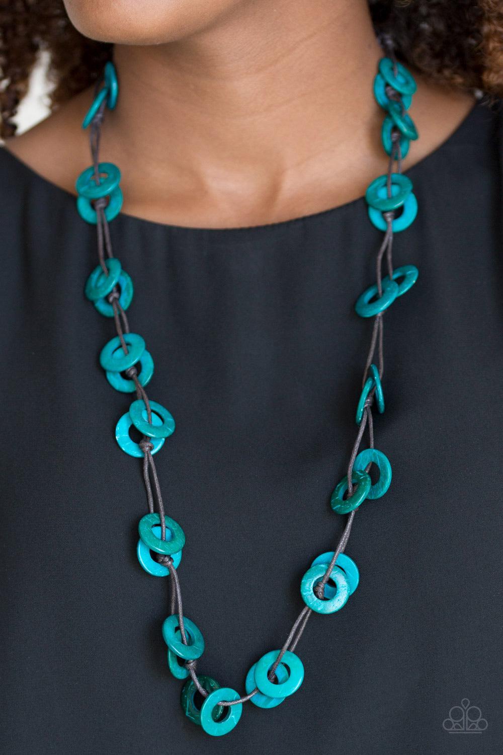 Paparazzi Accessories Waikiki Winds - Blue Shiny brown cording knots around refreshing blue wooden discs, creating a colorful display across the chest. Features a button loop closure. Sold as one individual necklace. Includes one pair of matching earrings