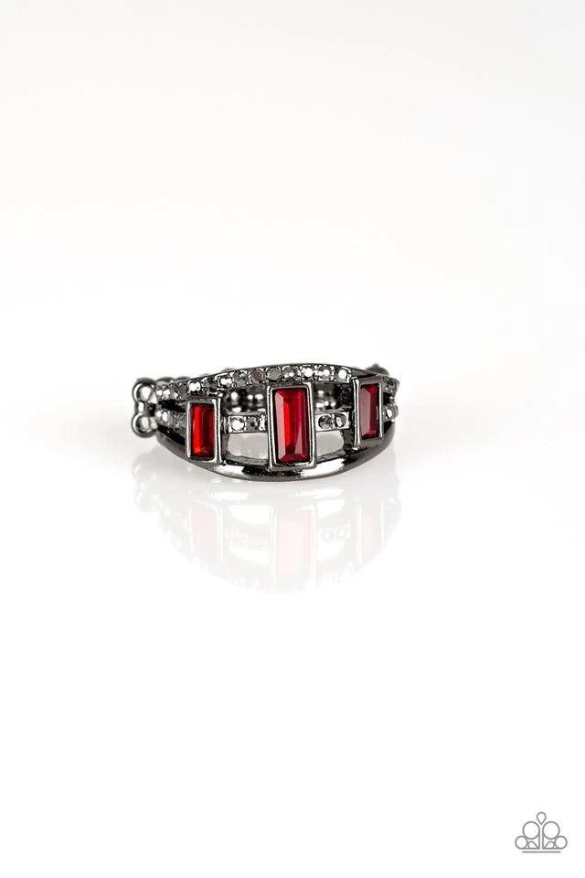 Paparazzi Accessories Noble Nova - Red Three red emerald-cut rhinestones are encrusted along three gunmetal bands radiating with smooth surfaces and sections of glittery hematite rhinestones for an edgy fashion. Features a stretchy band for a flexible fit