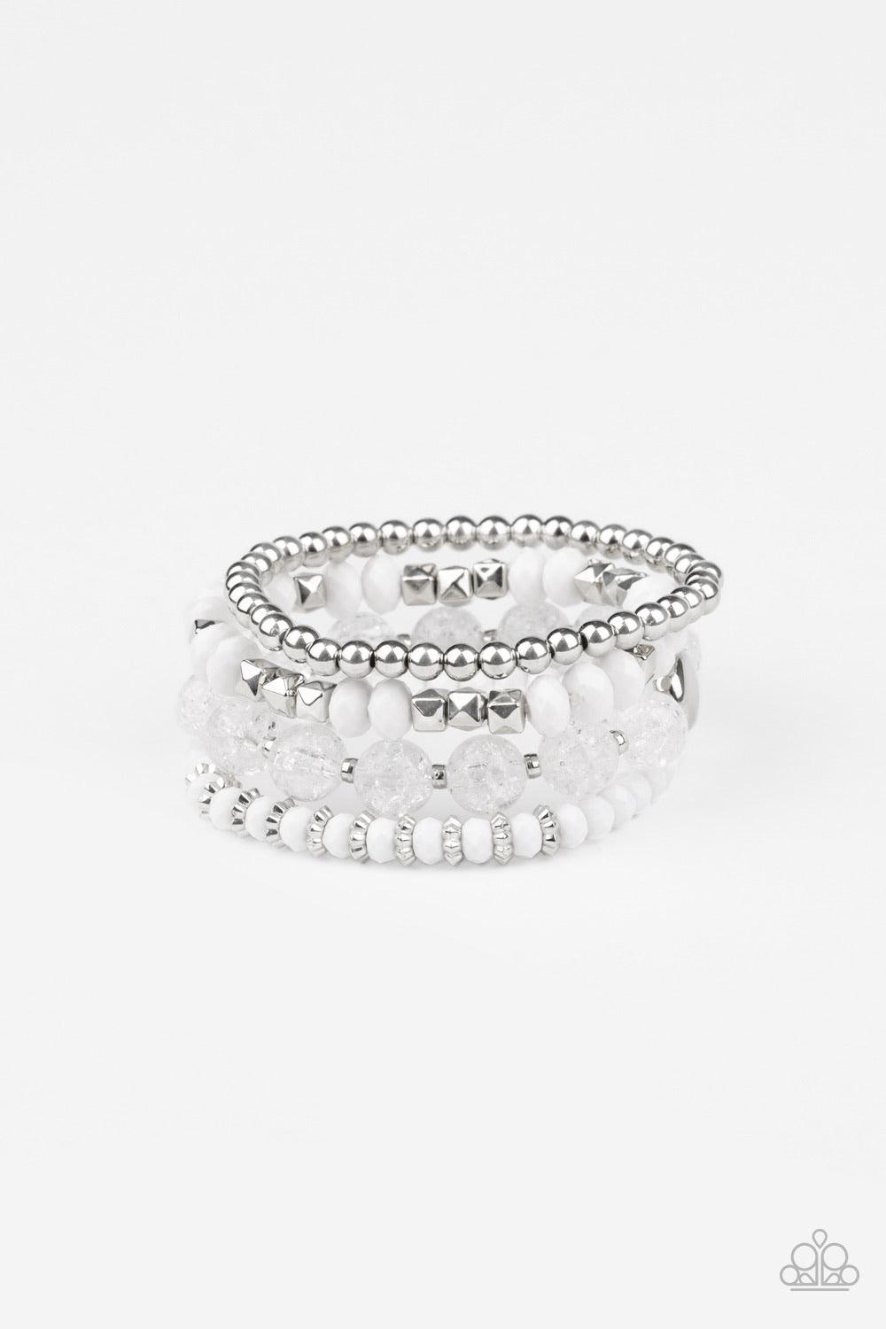 Paparazzi Accessories Layered Luster - White A mismatched assortment of silver, white, and crackling white glass-like beads are threaded along stretchy bands around the wrist, creating colorful layers. Sold as one set of four bracelets. Jewelry
