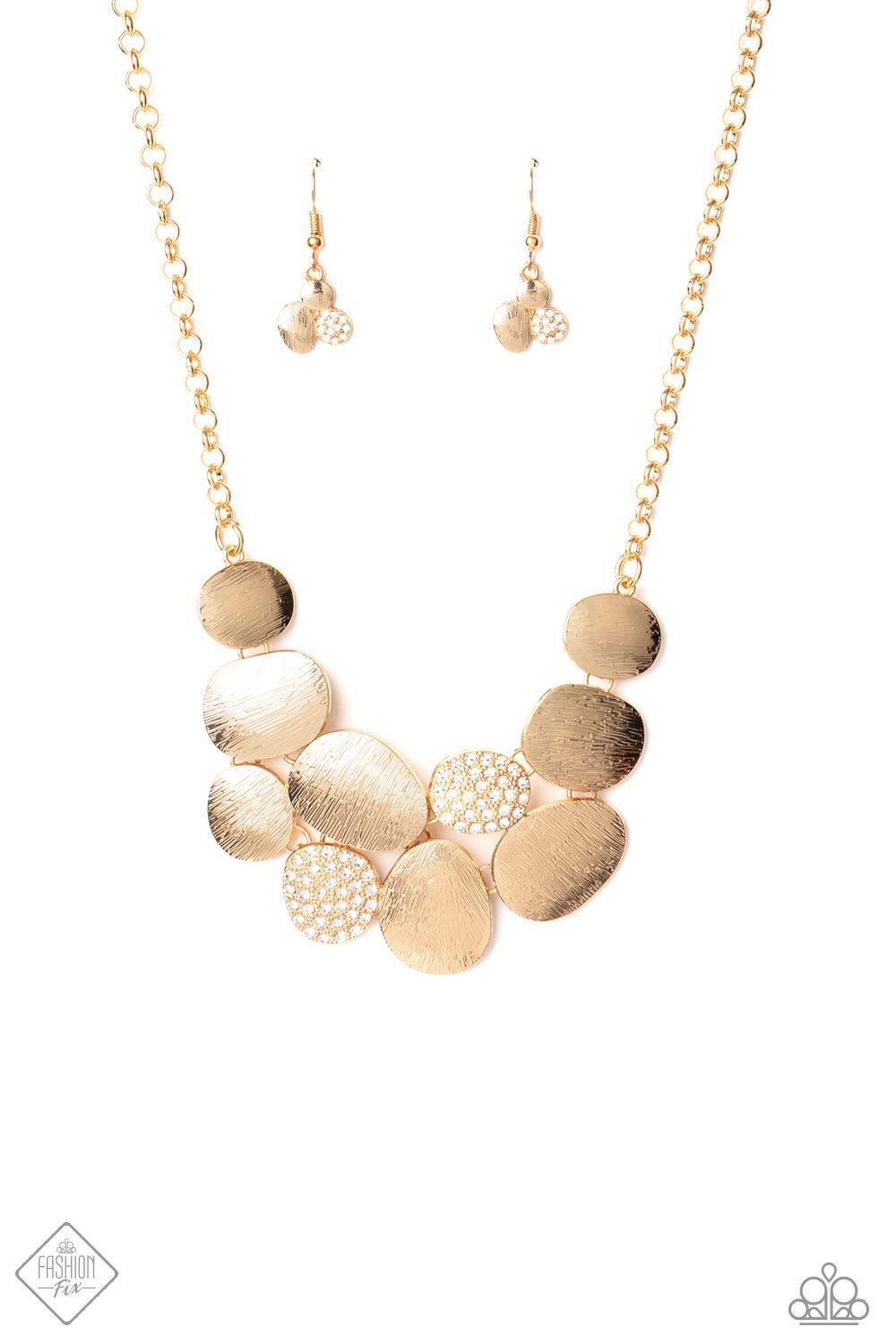 Paparazzi Accessories A Hard LUXE Story - Gold A collection of asymmetrical oval discs connect into a clustered pendant below the collar for a refined flair. Etched linear textures or white rhinestones adorn each disc, offering a gorgeous collision of tex