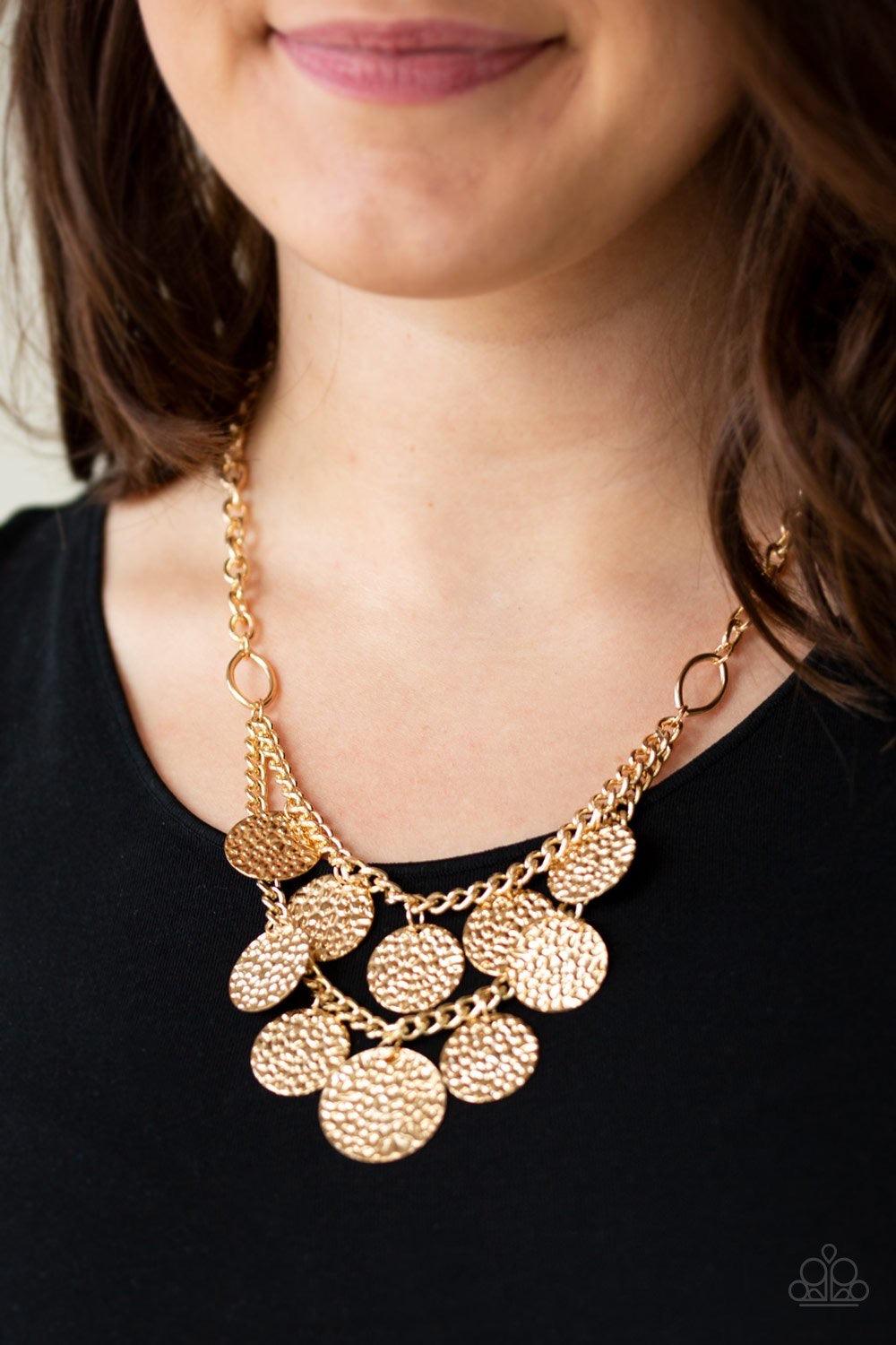Paparazzi Accessories Work Every CHIME ~Gold Rippling with glistening textures, glistening gold discs dance along two shimmery gold chains, creating an edgy fringe below the collar. Features an adjustable clasp closure. Sold as one individual necklace. In