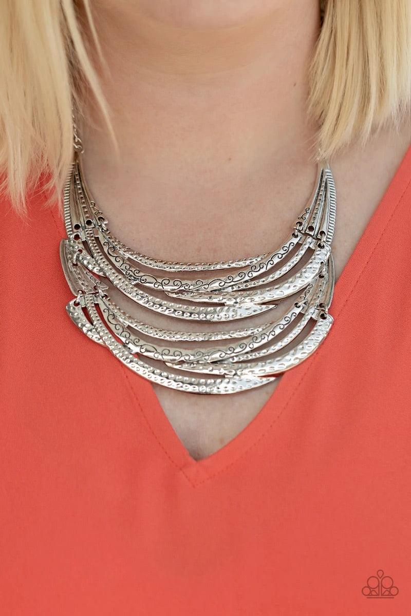 Paparazzi Accessories Read Between The Vines - Silver Stamped in sections of vine-like patterns, abstract hammered plates and overlapping silver bars link into an exaggerated pendant below the collar for a statement-making look. Features an adjustable cla