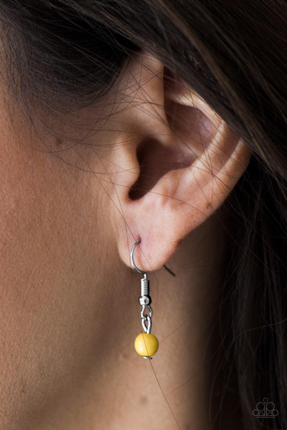 Paparazzi Accessories Wildflower Walt - Yellow A polished yellow bead is pressed into the center of a silver frame etched in floral details. Brushed in an antiqued shimmer, the dainty pendant swings below the collar in a whimsical fashion. Features an adj