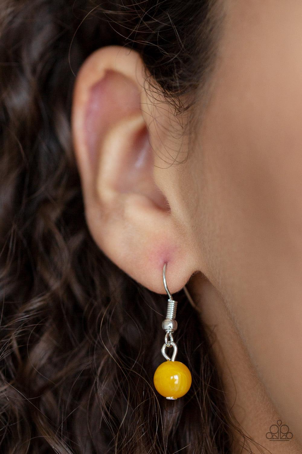 Paparazzi Accessories Colorfully Cosmopolitan - Yellow Infused with a plain silver chain, a collection of round and faceted yellow acrylic beads link below the collar for a whimsically colorful finish. Features an adjustable clasp closure. Jewelry