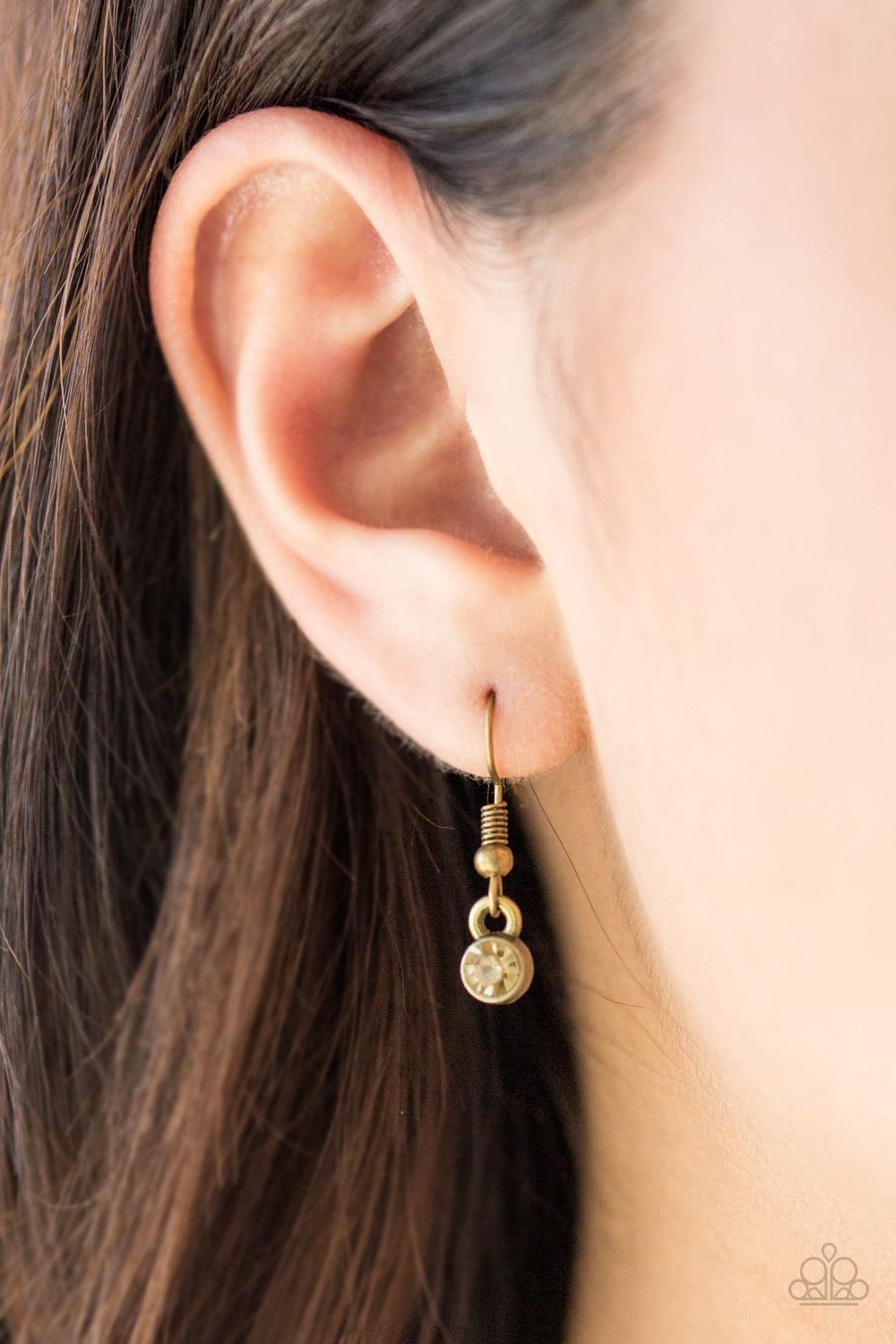 Paparazzi Accessories Stardom Shine - Brass A pearly brass bead is pressed into a dazzling topaz rhinestone encrusted frame, creating a refined pendant below the collar. Sold as one individual necklace. Includes one pair of matching earrings. Jewelry
