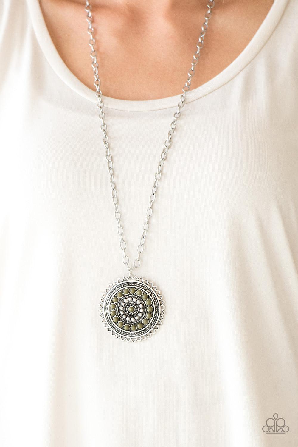 Paparazzi Accessories Lost SOL - Green Radiating with shimmery sunburst details, a Martini Olive beaded silver pendant swings from the bottom of a lengthened silver chain for a tribal inspired look. Features an adjustable clasp closure. Sold as one indivi