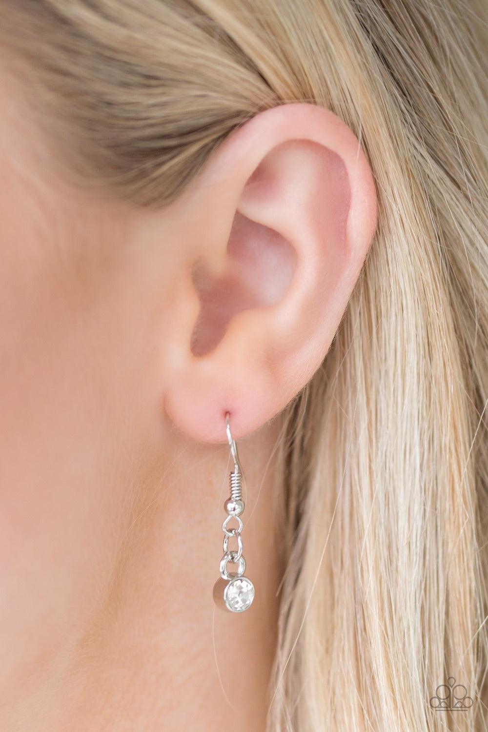 Paparazzi Accessories Grotto Grandeur - White Mismatched asymmetrical frames join below the collar. Sprinkled in dazzling white rhinestones, the delicately hammered silver frames connect with dramatic white gems for a glamorous finish. Features an adjusta
