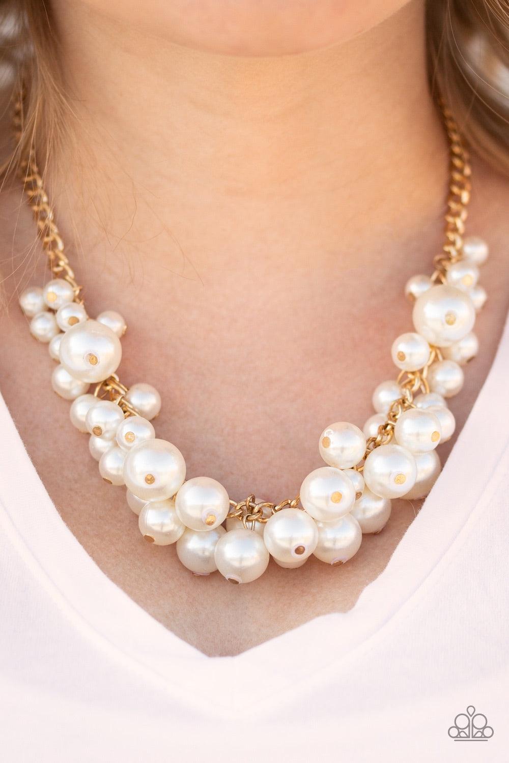 Paparazzi Accessories Glam Queen - Gold Varying in size, bubbly white pearls cascade from the bottom of a bold gold chain, creating a dramatically clustered fringe below the collar. Features an adjustable clasp closure. Jewelry