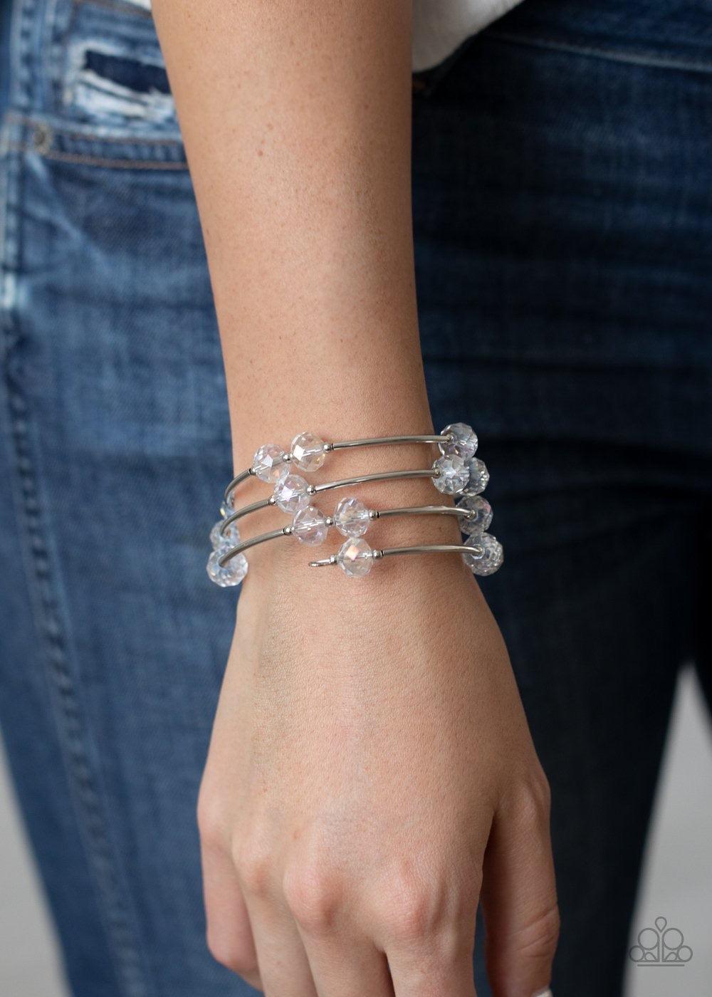 Paparazzi Accessories Dreamy Demure - White Glittery white crystal-like beads, silver rods, and dainty silver beads are threaded along a coiled wire, creating a glamorous infinity wrap style bracelet around the wrist. Sold as one individual bracelet. Jewe