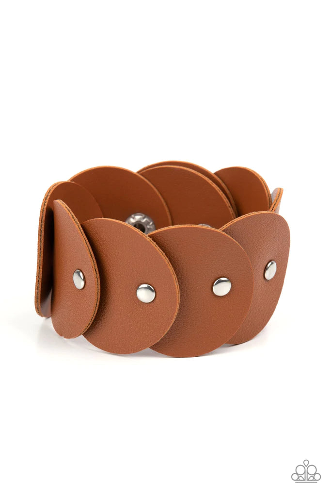 Paparazzi Accessories Rhapsodic Roundup - Brown Overlapping tan leather discs are studded in place around the wrist, resulting in a dizzying rustic centerpiece. Features an adjustable snap closure. Sold as one individual bracelet. Jewelry