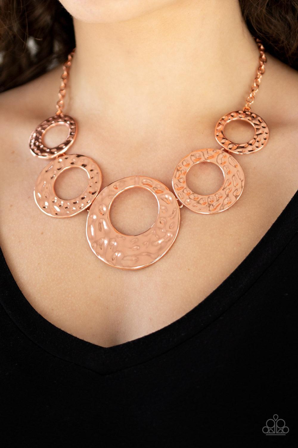 Paparazzi Accessories Mildly Metro - Copper Gradually increasing in size, hammered shiny copper circles link below the collar for a statement-making look. Features an adjustable clasp closure Jewelry