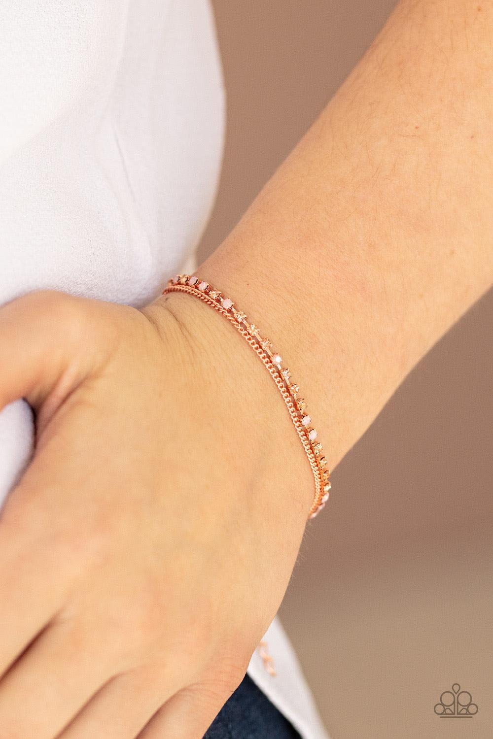 Paparazzi Accessories Double The Diamonds - Copper Infused with a dainty shiny copper chain, a glittery collection of peach and opaque pink rhinestones delicately link across the wrist, creating glittery layers. Features an adjustable clasp closure. Sold