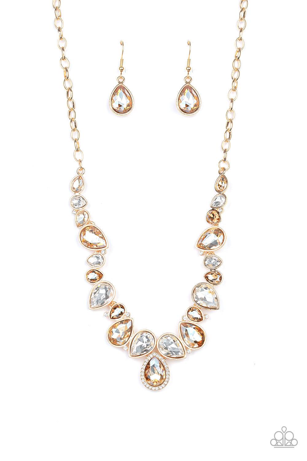 Paparazzi Accessories I Want It All - Gold A sassy combination of golden and white teardrop gems delicately link into a stunning piece below the collar. Dainty white rhinestones are scattered through the piece for unexpected hints of shimmer. Features an