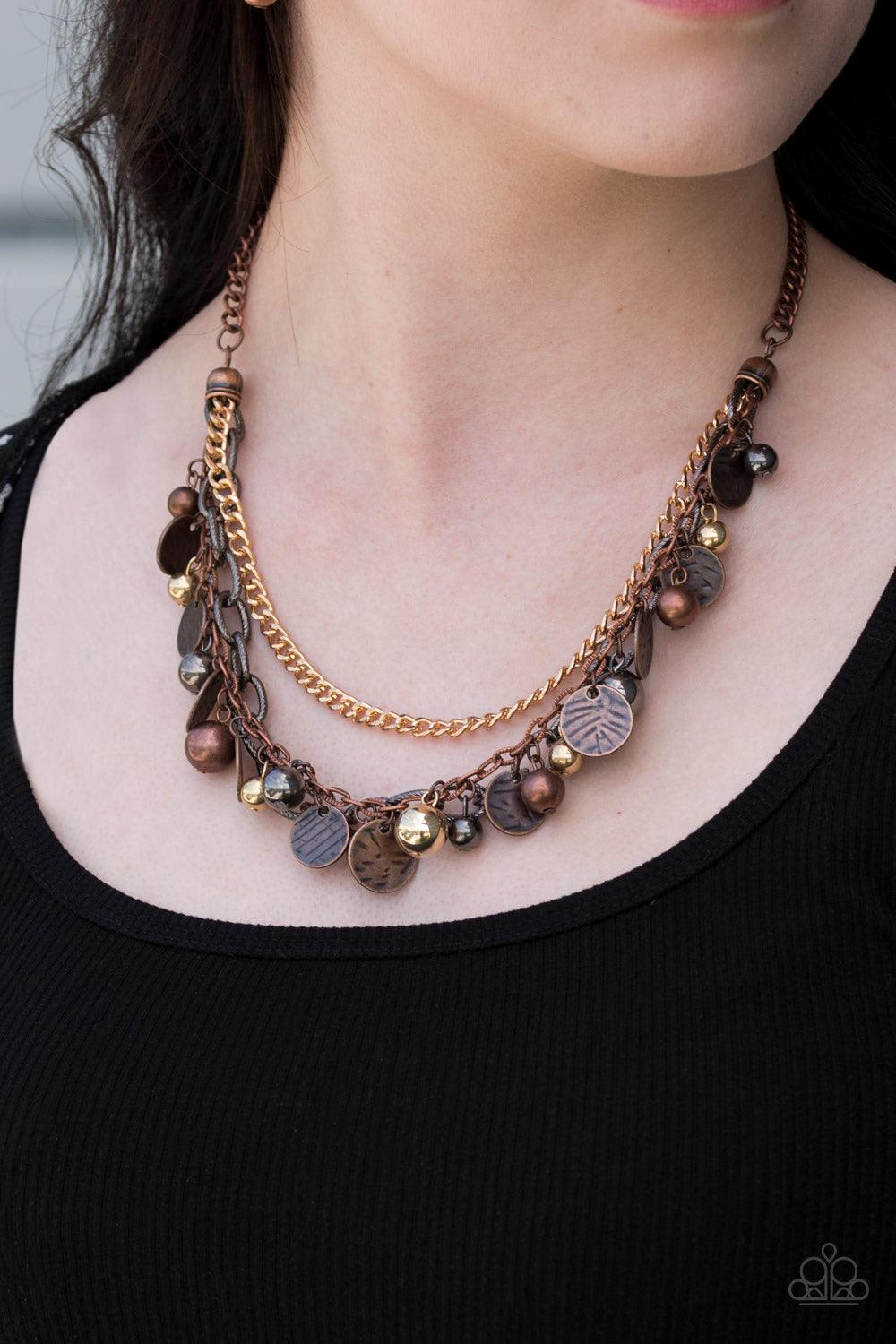 Paparazzi Accessories Cast Away Treasure ~Multi Varying in shape and shimmer, a mishmash of copper, gold and gunmetal chains layer below the collar. Infused with classic gold, copper and gunmetal beads, textured copper discs swing from the bottom of the l