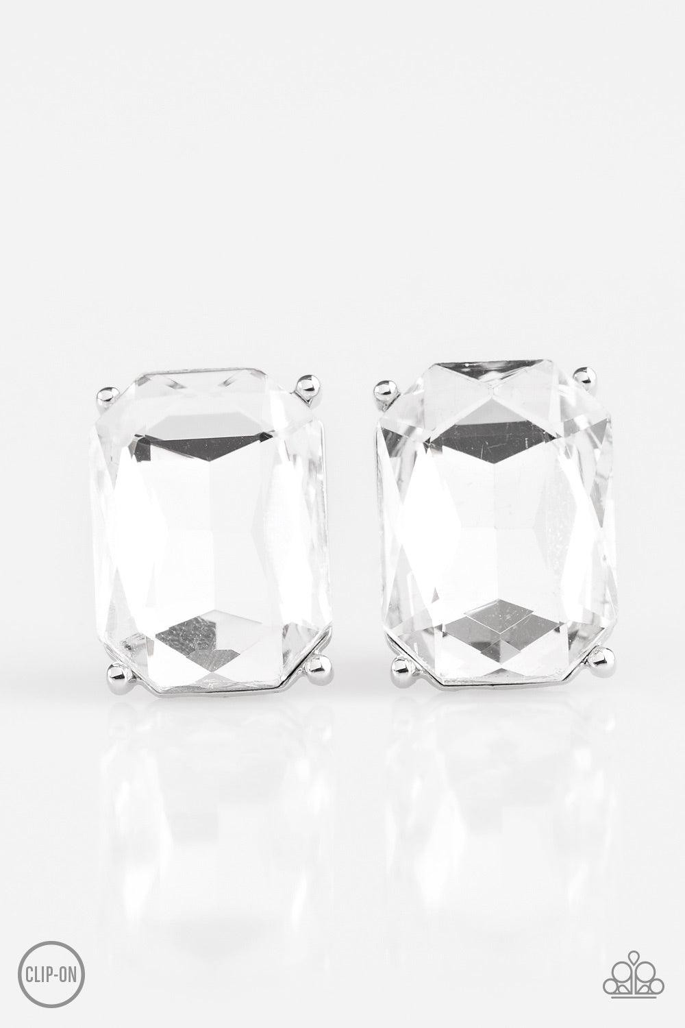 Paparazzi Accessories Opera House Hustle - White *Clip-On Featuring a regal emerald style cut, a glassy gem is pressed into a classic silver frame for a dramatic look. Earring attaches to a standard clip-on fitting. Jewelry