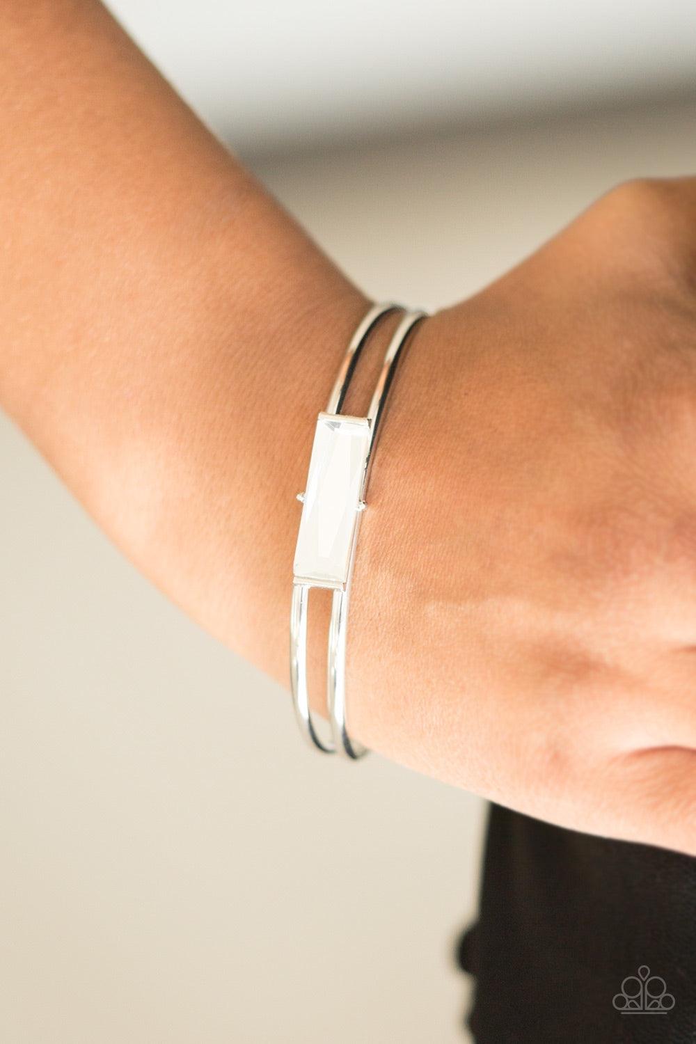 Paparazzi Accessories Choose Chic - White Featuring an elegant emerald style cut, a glassy white gem is pressed into the center of a dainty silver cuff for a regal look. Jewelry