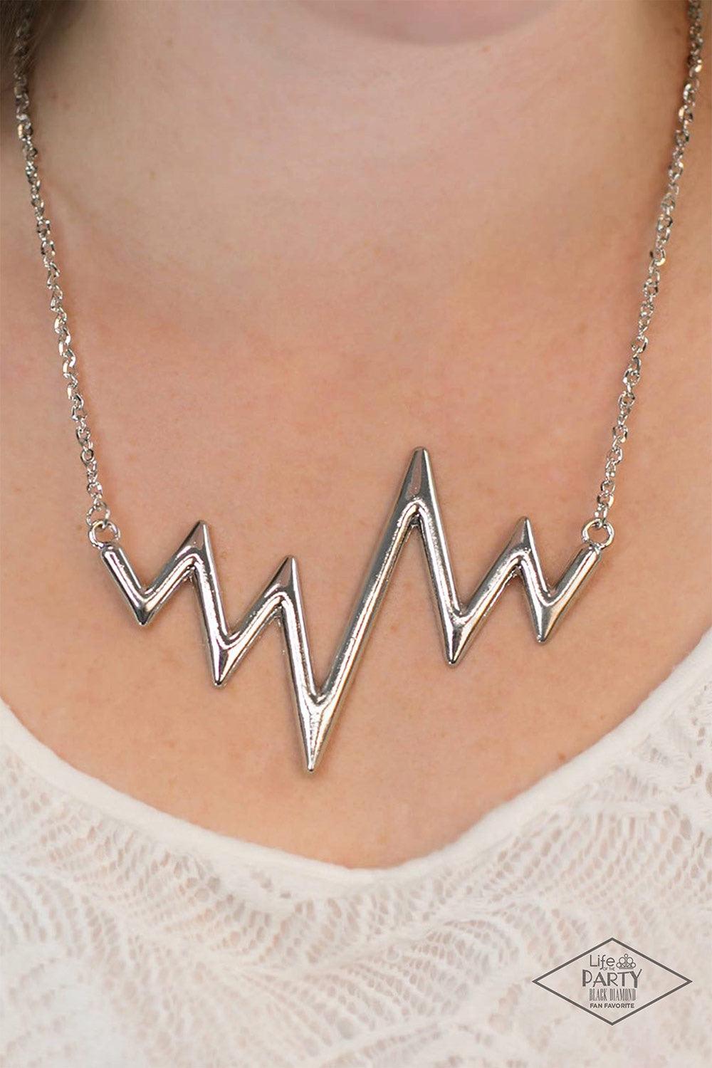 Paparazzi Accessories In A Heartbeat - Silver Chunky silver zigzags dramatically into a trendy angular design that hangs from the bottom of a glistening silver chain. Features an adjustable clasp closure. Jewelry