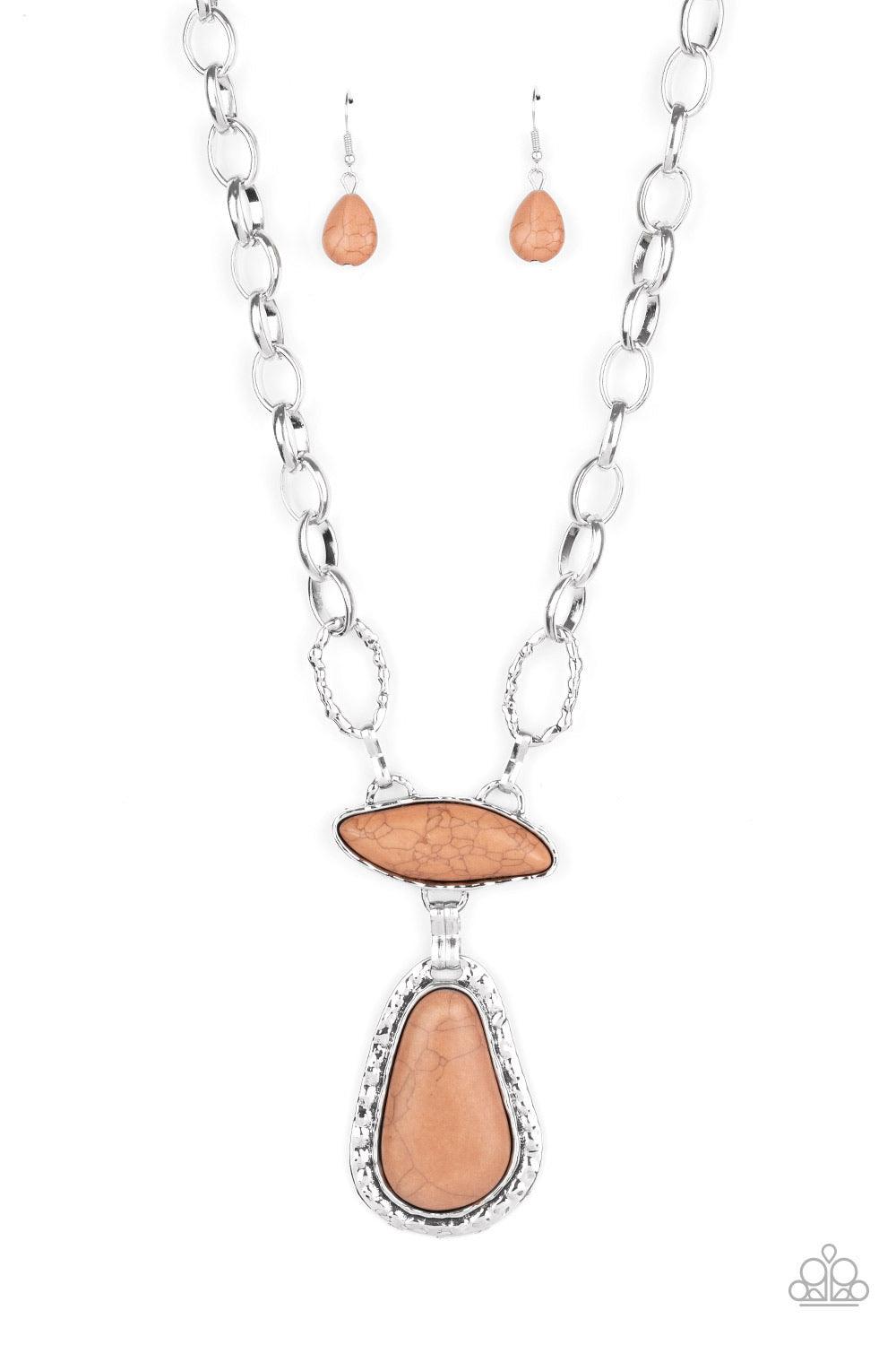 Paparazzi Accessories Rural Rapture - Brown Linked by handcrafted fittings, a pair of imperfect brown stones are pressed into asymmetrical hammered silver frames as they stack below the collar. Oversized silver links and a pair of hammered links form into