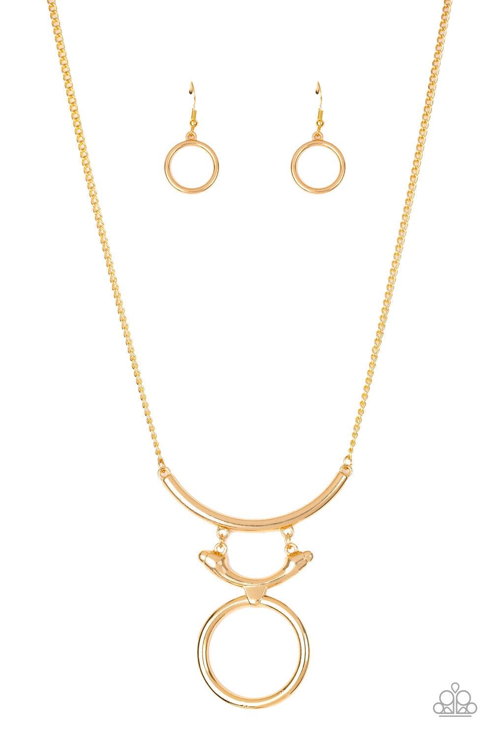 Paparazzi Accessories Walk Like An Egyptian - Gold Two glistening gold crescents attach to a large gold hoop, creating a tribal inspired pendant below the collar. Features an adjustable clasp closure. Jewelry