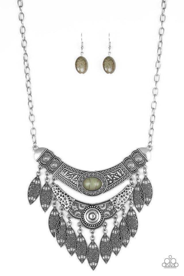 Paparazzi Accessories Island Queen - Green Featuring a collision of hammered, studded, and embossed patterns, two silver half-moon plates dramatically stack below the collar. Swirling with studded filigree detail, ornate silver frames swing from the botto