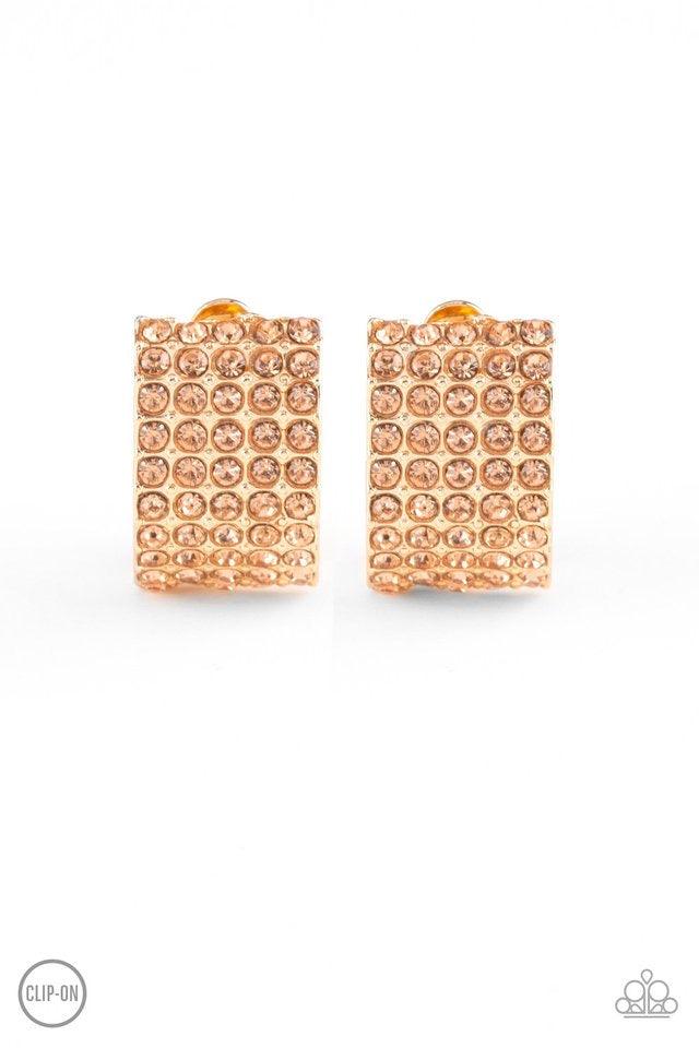 Paparazzi Accessories Hollywood HotShot - Gold *Clip-On Encrusted in row after row of glittery peach rhinestones, a radiant gold ribbon curls around the ear for a glamorous look. Earring attaches to a standard clip-on fitting. Sold as one pair of clip-on