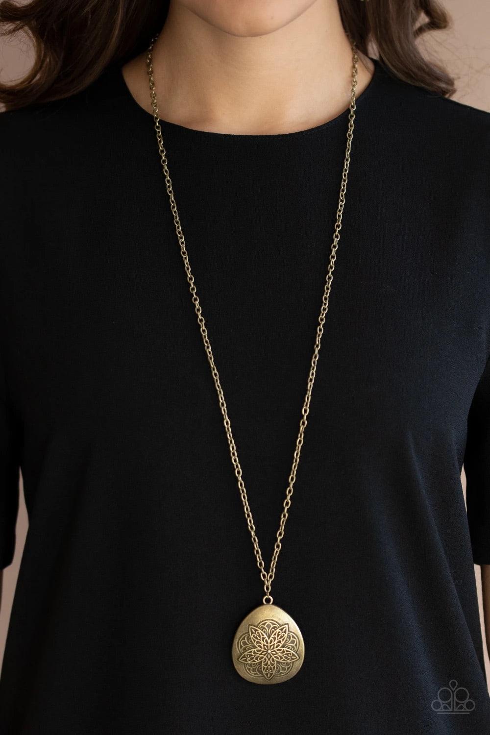 Paparazzi Accessories Rustic Renaissance - Brass Embossed in a flowery mandala-like pattern, an asymmetrical brass teardrop frame swings from the bottom of a lengthened brass chain for a rustic flair. Features an adjustable clasp closure. Sold as one indi