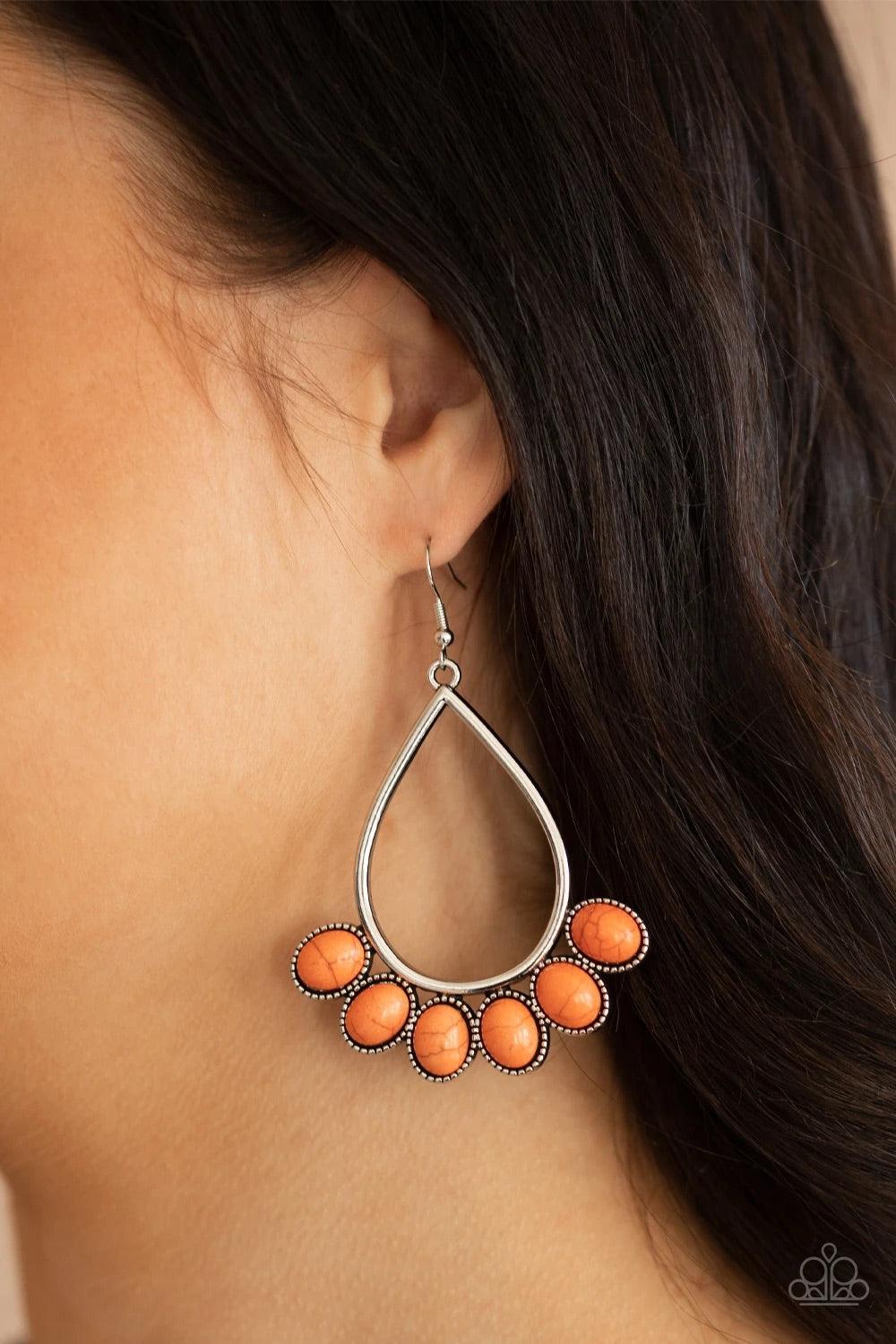 Paparazzi Accessories Stone Sky - Orange Featuring decorative silver fittings, smooth orange stones fan out from the bottom of an airy silver teardrop frame for a seasonal flair. Earring attaches to a standard fishhook fitting. Sold as one pair of earring