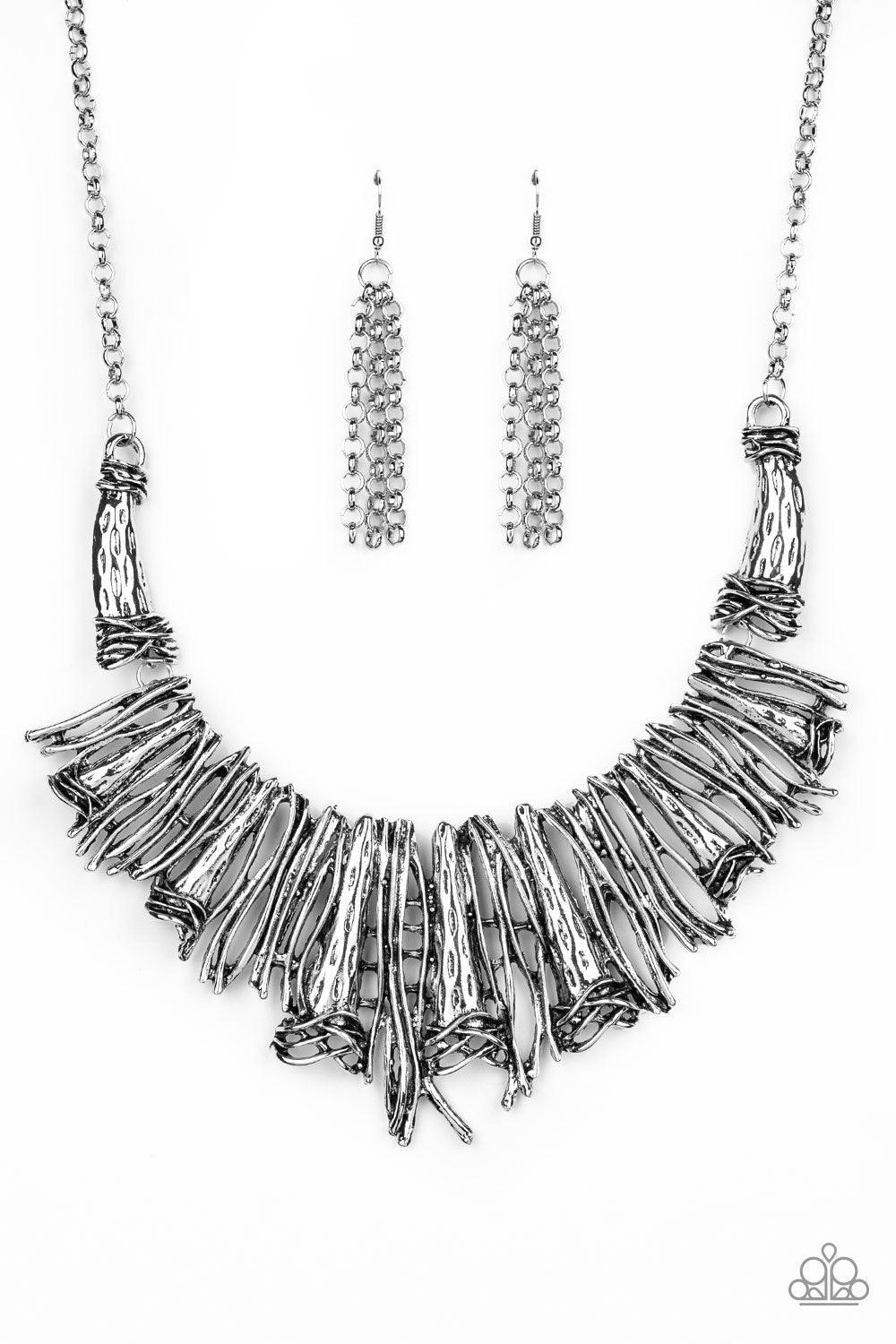 Paparazzi Accessories In the MANE-Stream - Silver Brushed in an antiqued shimmer, a collision of glistening silver bars and hammered silver accents coalesce into an abstract statement piece below the collar for a fierce industrial look. Features an adjust