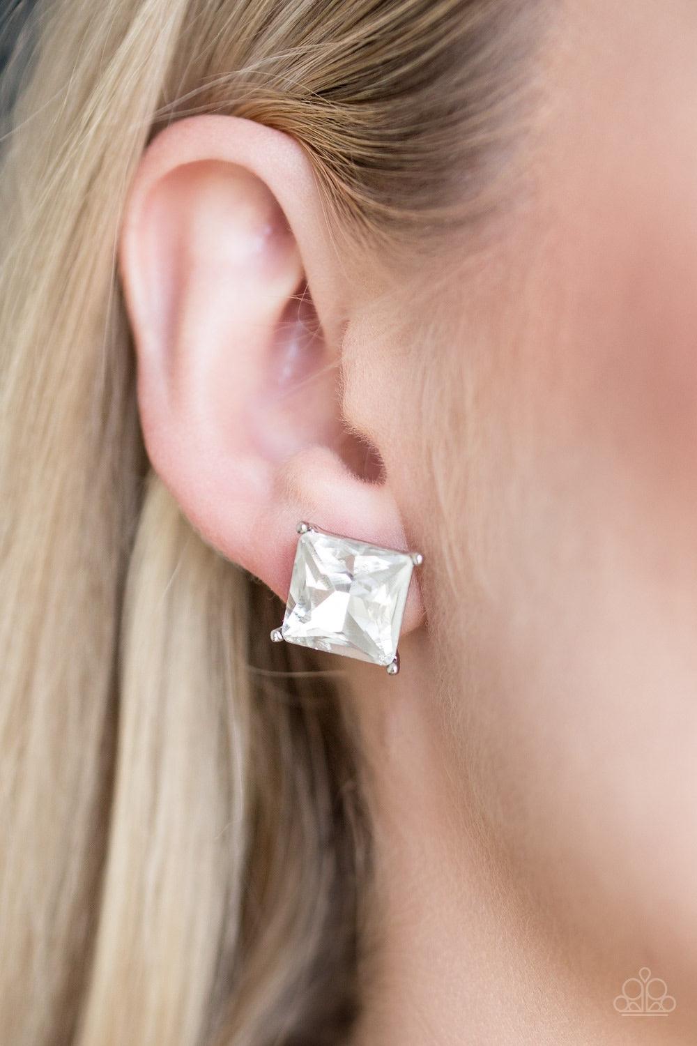 Paparazzi Accessories The Big Bang - White Featuring a timeless princess style cut, a dramatic white gem is pressed into a sleek silver frame for a timeless look. Earring attaches to a standard post fitting. Jewelry