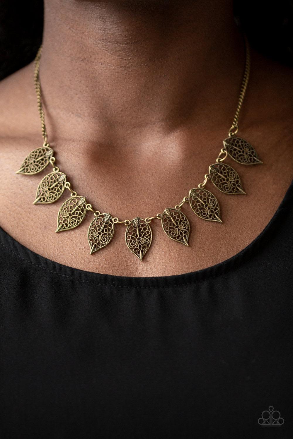 Paparazzi Accessories Leafy Lagoon - Brass Swirling with dotted filigree, dainty brass leaf frames swing from the bottom of a glistening brass chain, creating a whimsical fringe below the collar. Features an adjustable clasp closure. Sold as one individua