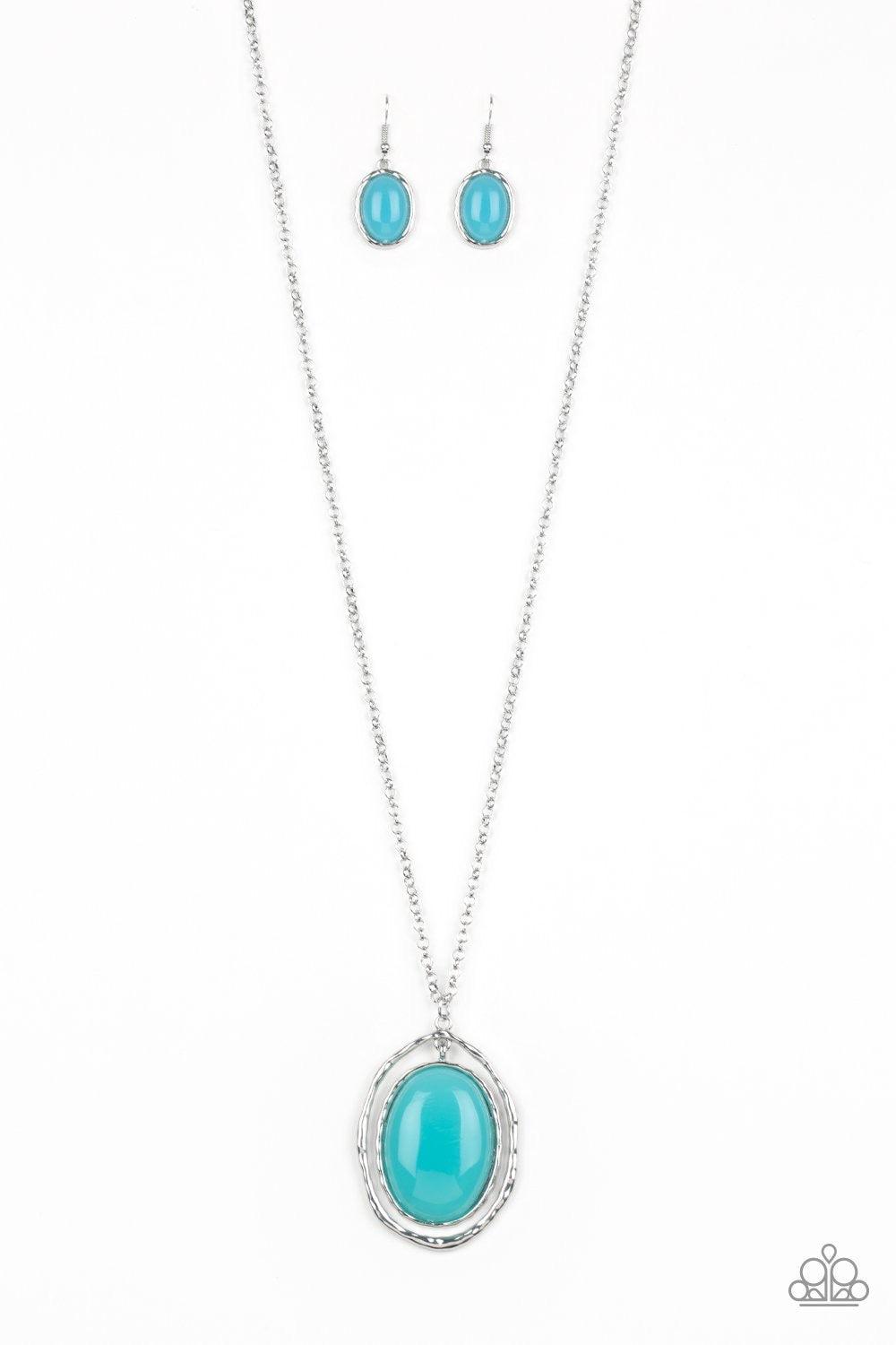 Paparazzi Accessories Harbor Harmony - Blue A dewy blue bead is pressed into the center of a stacked silver frame radiating with shimmery hammered textures. The oversized pendant swings from the bottom of a lengthened silver chain, adding a whimsical pop