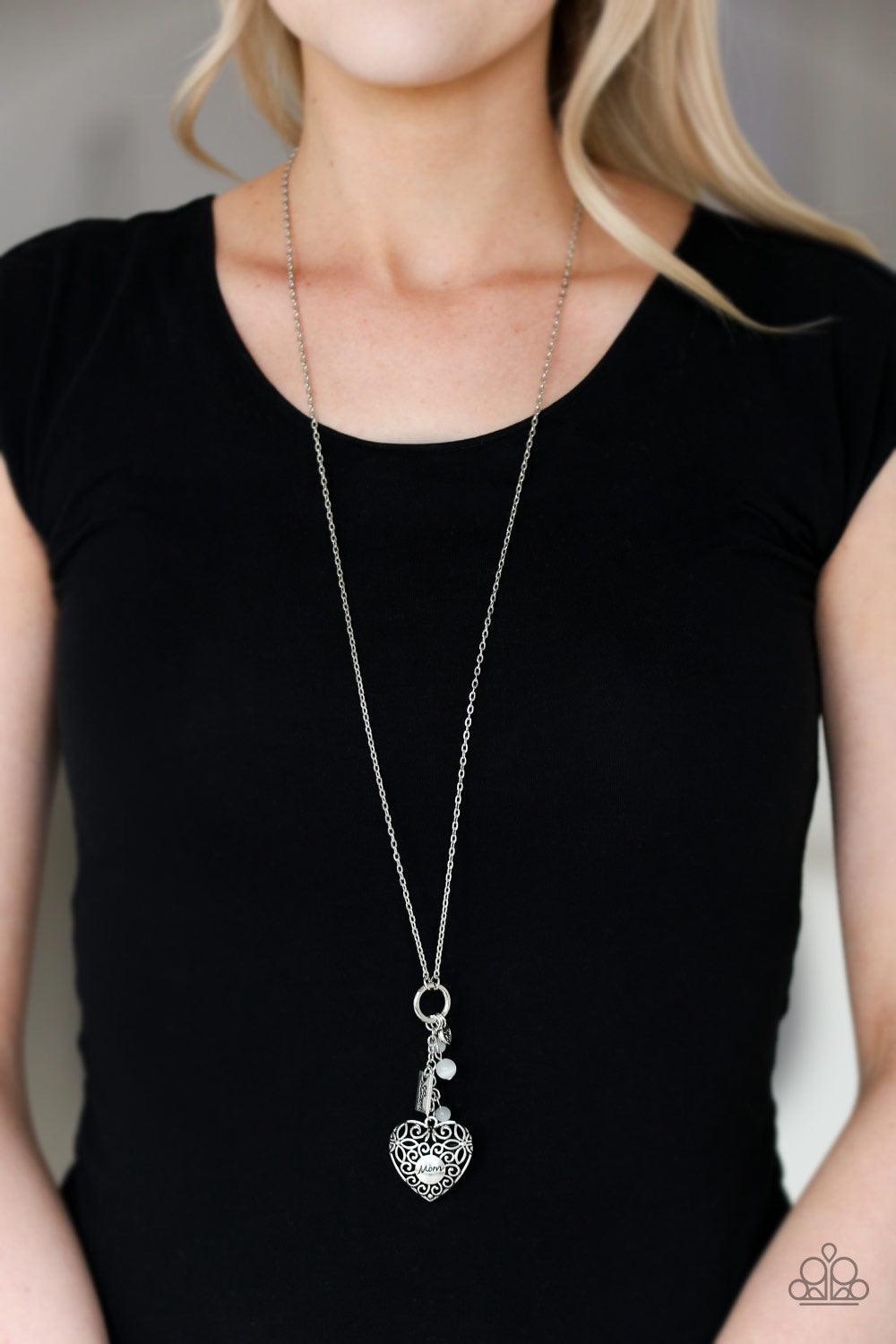 Paparazzi Accessories Mom Hustle - White Infused with white cat's eye accents, a dainty silver heart, rectangular frame stamped with "love", and a locket-like heart stamped with the word "mom", collect at the bottom of a silver chain for a vintage inspire