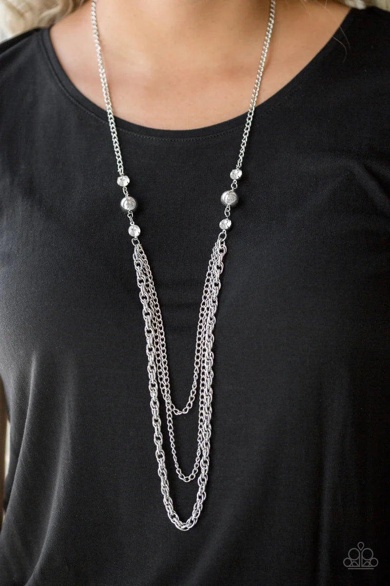 Paparazzi Accessories RITZ it All - White Glittery white rhinestones and oversized silver beads give way to layers of mismatched silver chains for a refined look. Features an adjustable clasp closure. Sold as one individual necklace. Includes one pair of