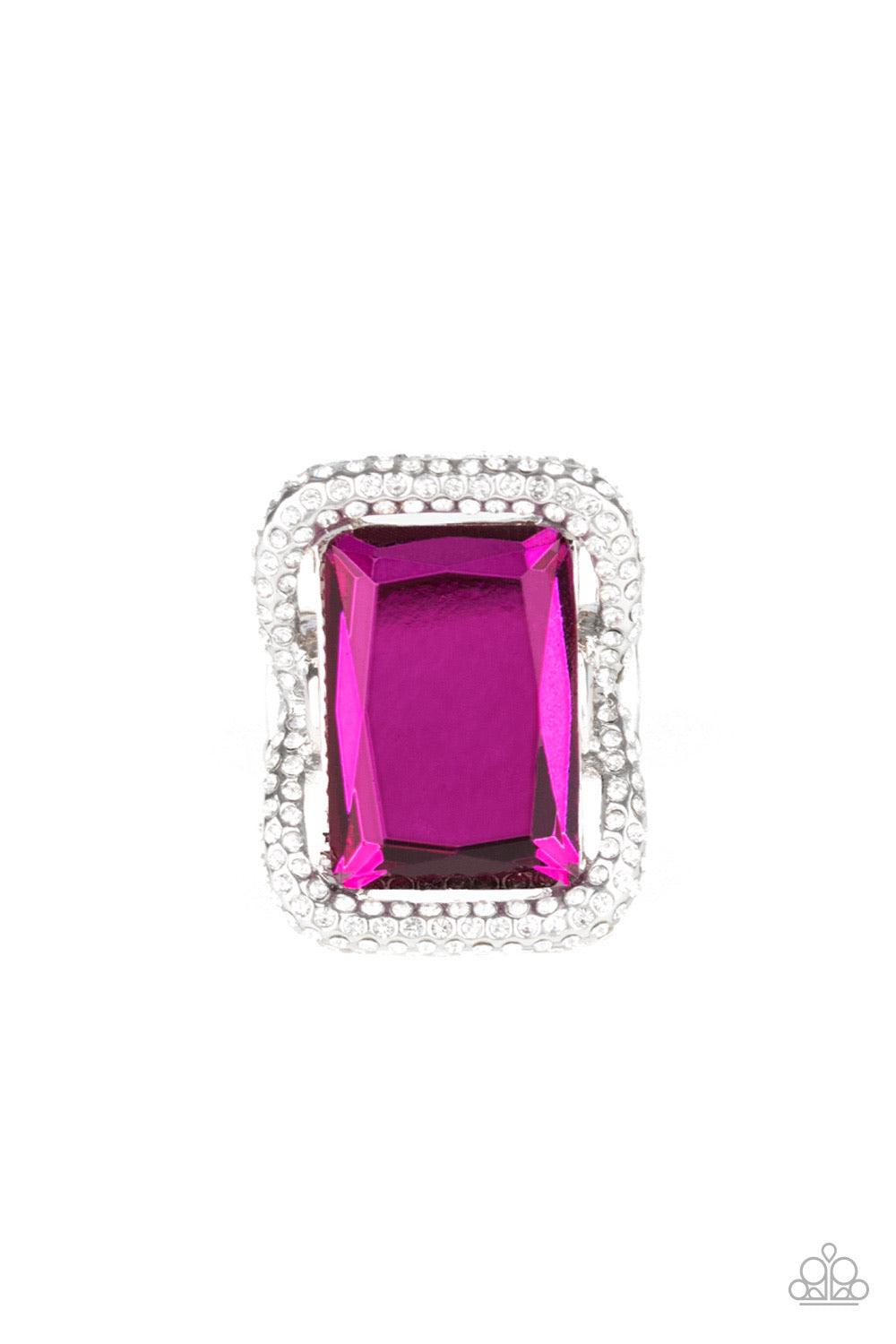 Paparazzi Accessories Deluxe Decadence - Pink Featuring a regal emerald style cut, an oversized pink gem nestles inside a rounded square silver frame encrusted in glassy white rhinestones for a dramatically glamorous look. Features a stretchy band for a f
