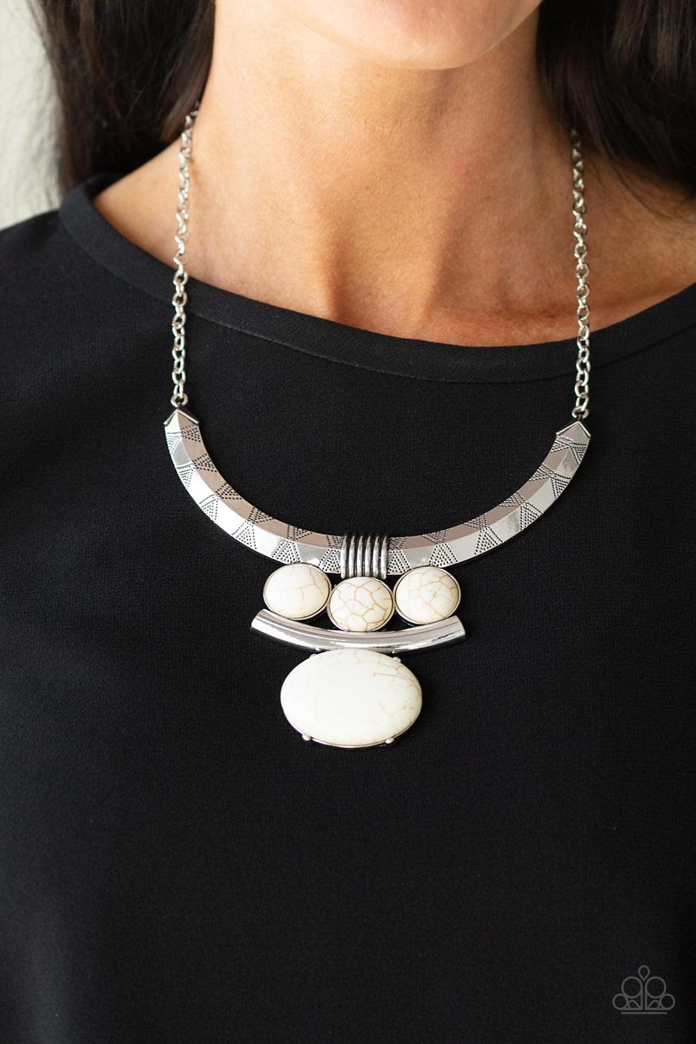 Paparazzi Accessories Commander in CHIEFETTE - White Oversized white stone accents alternate with mismatched silver frames, coalescing into a dramatic tribal inspired pendant below the collar. Features an adjustable clasp closure. Sold as one individual n