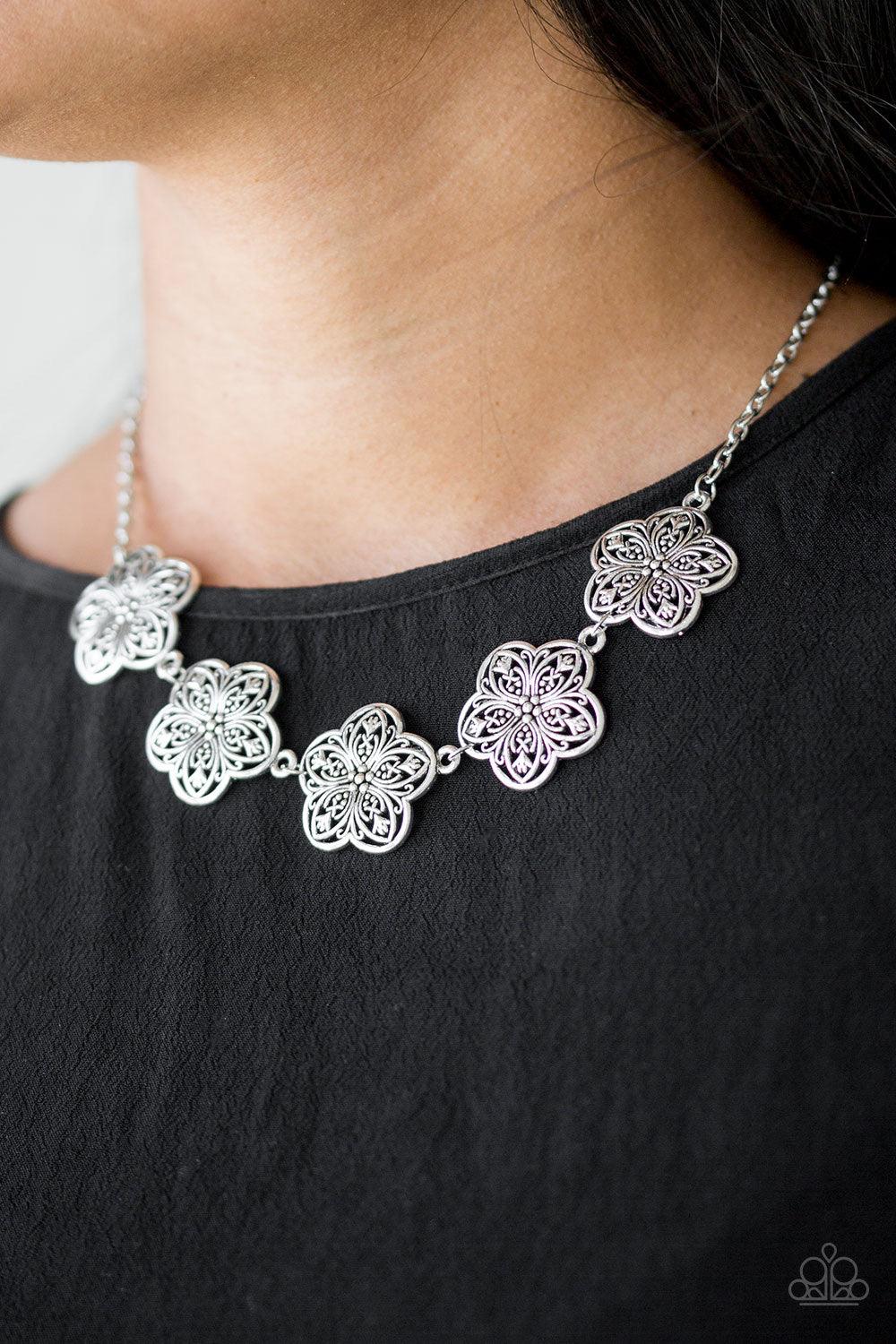 Paparazzi Accessories Garden Groove - Silver Ornate silver flowers connect below the collar for a simply seasonal look. Features an adjustable clasp closure. Sold as one individual necklace. Includes one pair of matching earrings. Jewelry