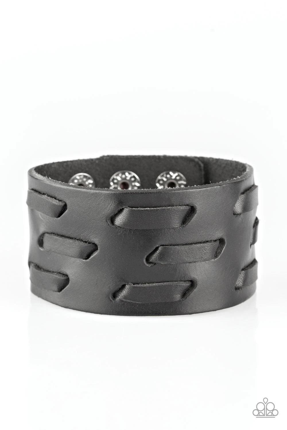 Paparazzi Accessories Be Your Own Huntsman - Black Black leather cording is laced across the front of a thick leather band, creating a rugged look around the wrist. Features an adjustable snap closure.Sold as one individual bracelet. Jewelry