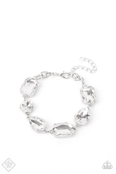Paparazzi Accessories Cosmic Treasure Chest - White A collection of oversized round, teardrop, and emerald cut rhinestones delicately link around the wrist, creating a blinding statement piece. Features an adjustable clasp closure. Sold as one individual