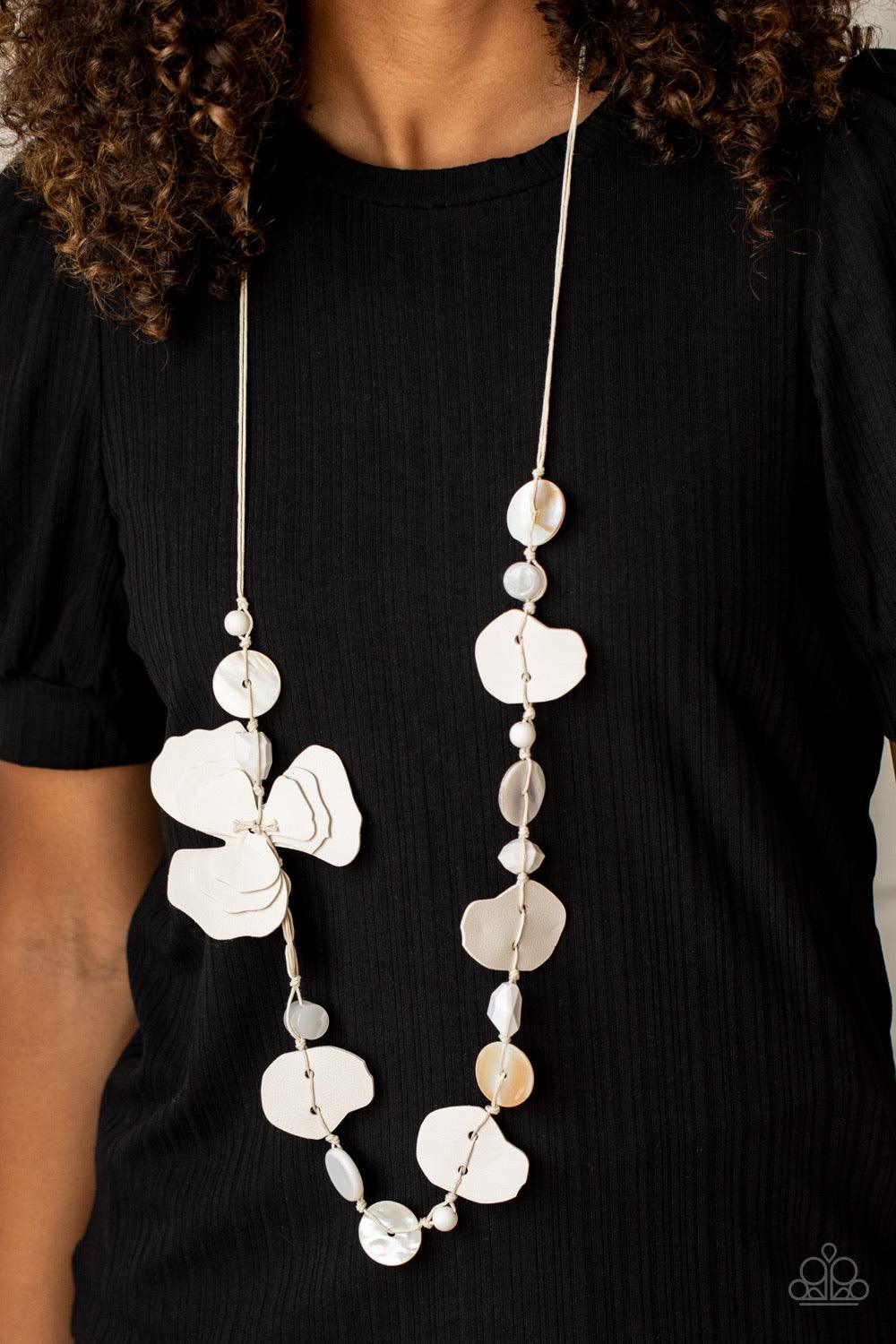 Paparazzi Accessories On Island Time - White A colorful compilation of shell-like discs, mismatched white acrylic beads, and petal-like white leather pieces knot along strands of white cording across the chest. The ruffled pieces of leather stack into a w