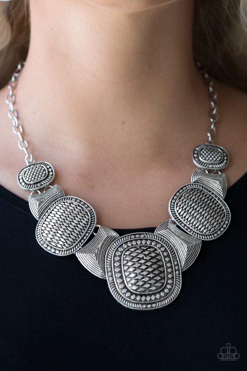 Paparazzi Accessories Prehistoric Powerhouse - Silver Radiating with geometric and linear details, ornate silver plates link below the collar for a bold tribal look. Features an adjustable clasp closure. Jewelry