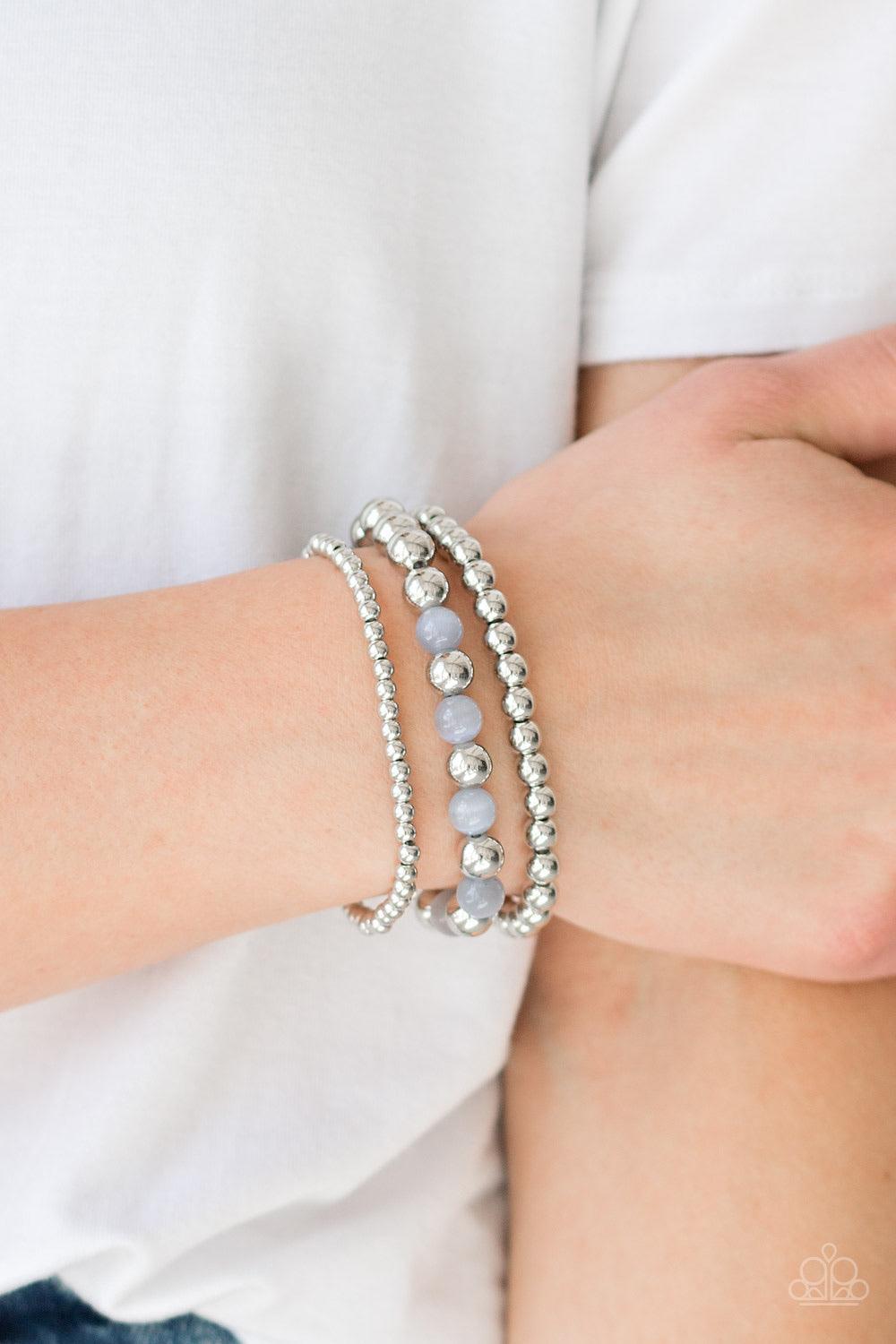 Paparazzi Accessories Always On The Glow - Silver Infused with glowing gray moonstones, shiny silver beads are threaded along stretchy bands for a whimsical look. Sold as one set of three bracelets. Jewelry