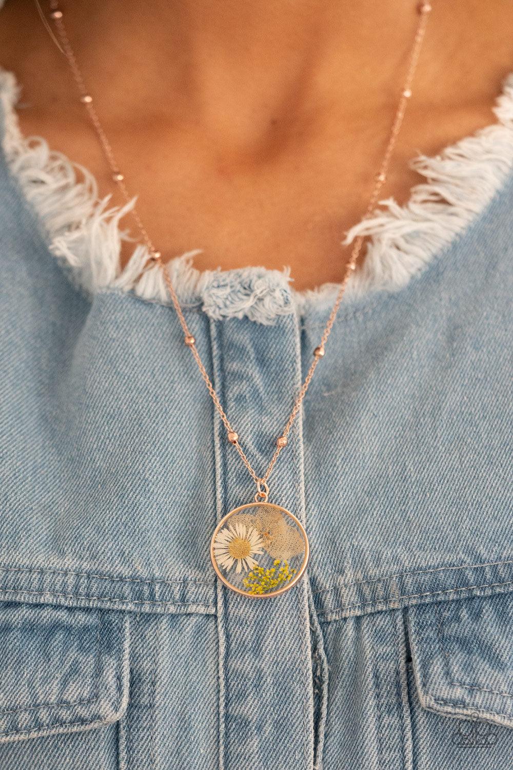 Paparazzi Accessories Floral Embrace - Rose Gold A delightful bouquet of pressed flowers encased in a rose gold frame gently sway from a delicate rose gold chain accented with rose gold beads. Features an adjustable clasp closure. Sold as one individual n