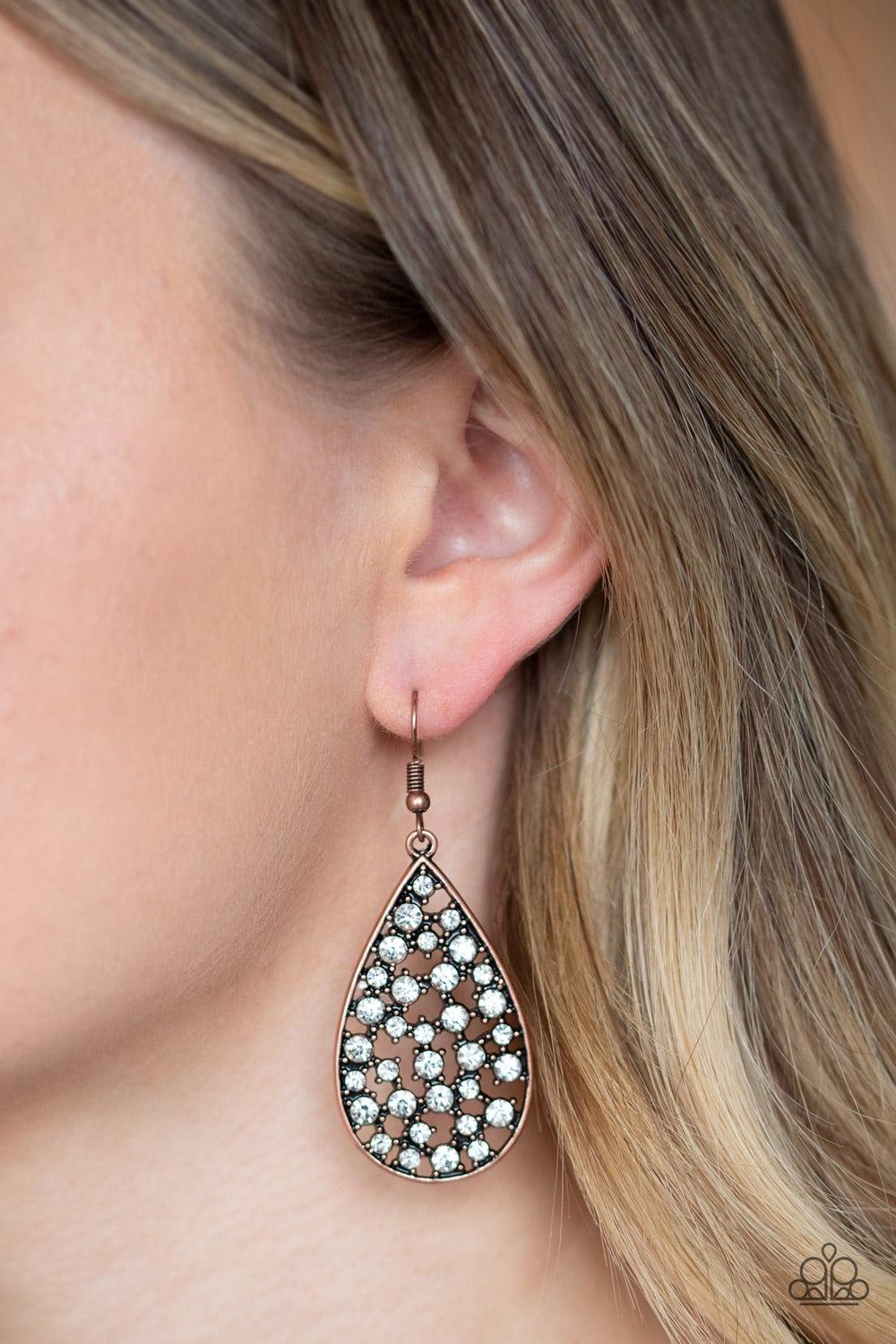 Paparazzi Accessories Call Me Ms Universe - Copper Hints of copper frames and glassy white rhinestones collect inside an airy copper teardrop, creating a gorgeous lure. Earring attaches to a standard fishhook fitting. Jewelry