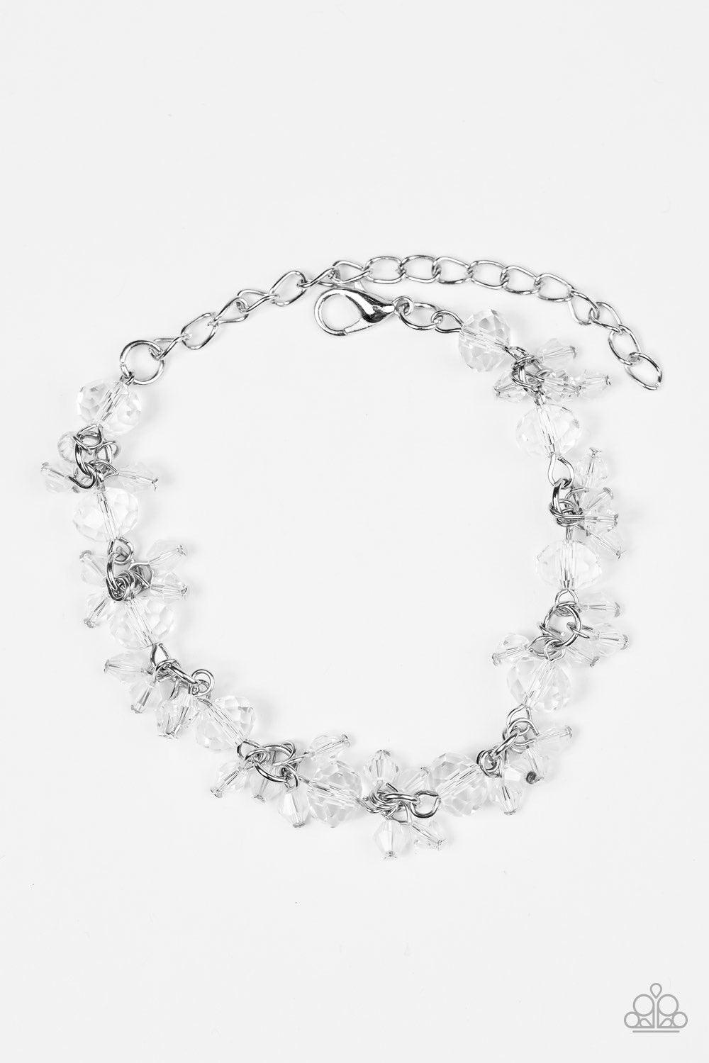 Paparazzi Accessories Oh, My Stars - White Glassy and faceted white crystal beading trickles along a silver chain, creating a dramatic fringe around the wrist. Featuring elegant pear-shaped cuts, iridescent crystals cluster atop the glassy gems for an inc