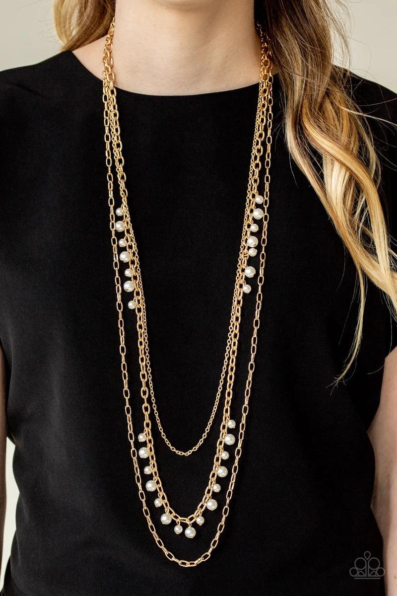 Paparazzi Accessories Pearl Pageant - Gold Three mismatched gold chains layer down the chest. Dainty white pearls cascade down one gold chain, adding a flirty twist to the timeless pearl palette. Features an adjustable clasp closure. Sold as one individua