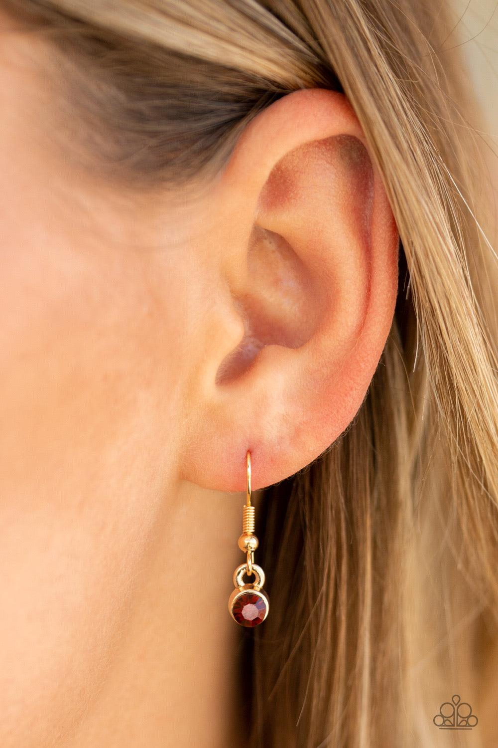 Paparazzi Accessories Flirtatiously Flashy - Brown Set atop a sleek gold fitting, a topaz heart-shaped gem swings from the bottom of a classic gold chain below the collar for a whimsical look. Features an adjustable clasp closure. Jewelry